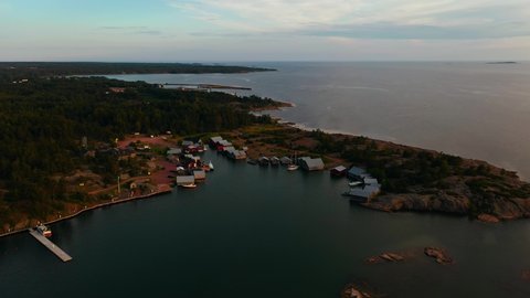 Aerial view towards a town of boathouses in Karingsund, Aland, Finland - approaching, drone shot