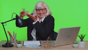 Senior businesswoman showing wasting or throwing money around hand gesture, more tips dreaming about big profit body language at office. Elderly mature woman isolated indoor on green chroma key studio - Powered by Shutterstock - Get 15% off with code: PIKWIZARD15