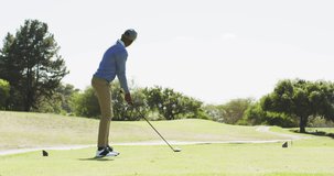 Video of african american man playing golf on golf filed. sporty, active lifestyle and playing golf concept.