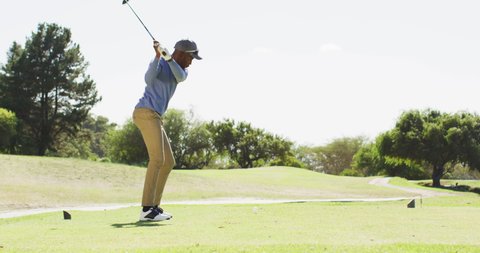 Video of african american man playing golf on golf filed. sporty, active lifestyle and playing golf concept.