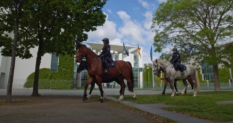 Germany - 05. 12 2022: German Chancellery in Berlin on Beautiful Spring Day. Police officers ride horses.