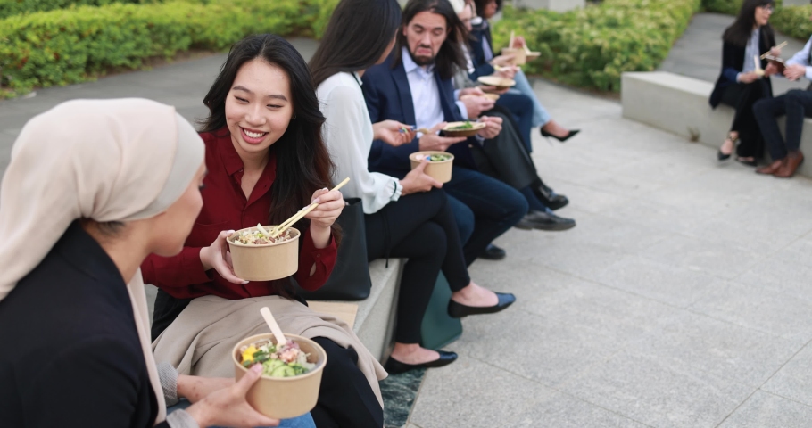 Multiethnic business people doing lunch break outdoor from office building - Meeting and entrepreneur concept 