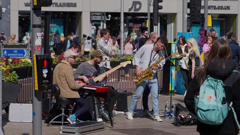 Street musicians busking at Royal Mile in Belfast - BELFAST, UNITED KINGDOM - APRIL 25, 2022