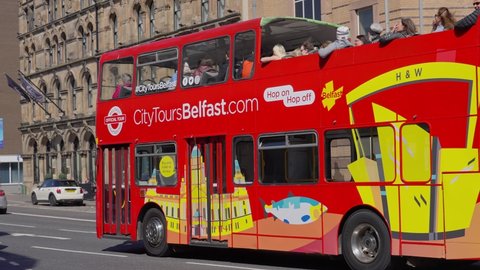 Sightseeing Bus in the city of Belfast - BELFAST, UNITED KINGDOM - APRIL 25, 2022 - BELFAST, UNITED KINGDOM - APRIL 25, 2022