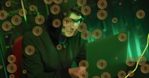 Animation of bitcoins over asian male hacker in server room. global technology and digital interface concept digitally generated video.
