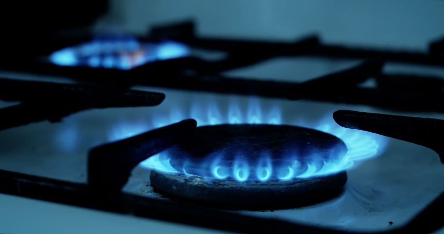 Natural Gas is burning in gas-stove in the kitchen. Concept of problems with natural gas in European union, rising gas prices. Royalty-Free Stock Footage #1090392615