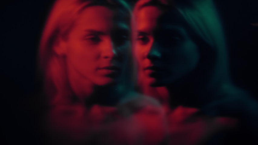 Dual personality. Multiple identity. Mental issue. Creative surrealism. Defocused woman double exposure silhouette in red neon light on dark background out of focus. Royalty-Free Stock Footage #1090394065