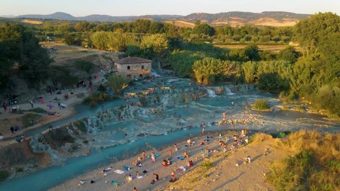 Toscane Italy, natural spa with waterfalls and hot springs at Saturnia thermal baths, Grosseto, Tuscany, Italy aerial view on the Natural thermal waterfalls couple at vacation at Saturnia Toscany