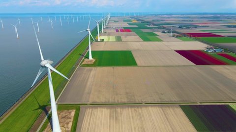 Offshore Windmill farm in the ocean Westermeerwind park, windmills isolated at sea on a beautiful bright day Netherlands Flevoland Noordoostpolder. Huge windmill turbines