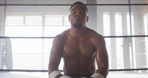 Video of fit and tired african american man after boxing training at gym. active, fit, sporty and healthy lifestyle, exercising at gym concept.
