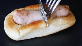 A video of bread sandwiched with sausages. Hot dog.