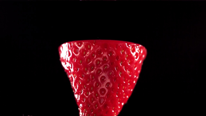 Strawberry Slice falling and splashing on black background. Food levitation concept. Slow Motion Royalty-Free Stock Footage #1090398709