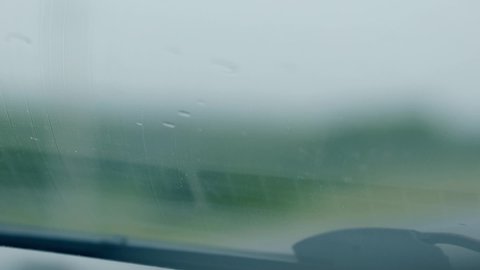 inspiring close view mechanical car wiper cleans small drops on automobile windscreen under rain