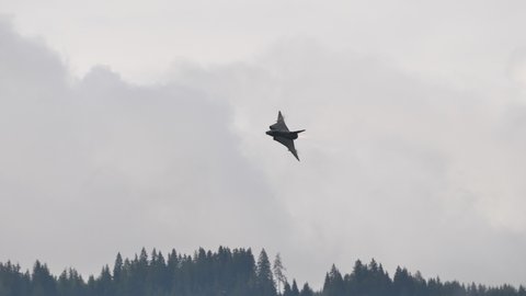 Zeltweg, Austria SEPTEMBER, 6, 2019 Fighter jet airplane in flight at high speed low altitude in a mountain valley with double delta wing and full afterburner. Saab J-35 Draken of Swedish Air Force