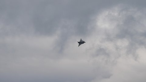 Zeltweg Austria SEPTEMBER, 6, 2019 Combat aircraft in flight with huge afterburner fire from the engine at full power in cloudy bad weather sky. Vintage Saab J-35 Draken of Swedish Air Force