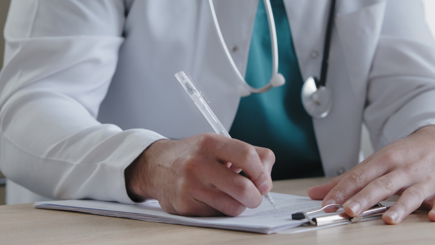 Unknown man doctor young male therapist in white uniform sit at clinic desk write detailed prescription for patient fill medical form checklist noticing pharmaceutical receipt prescribe dosage notes Royalty-Free Stock Footage #1090404643