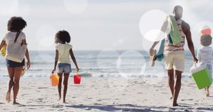 Animation of spots over african american family walking on sunny beach. healthy and active beach holiday concept digitally generated video.