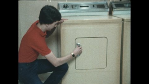 1980s: Man opens front loading dryer. Man pulls out shirt stuck to sock with static electricity. Foil in dryer.