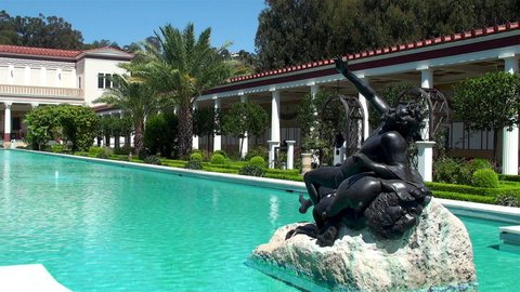 Pacific Palisades, LA, California, USA - AUGUST 23, 2012:
Drunken Satyr sculpture (reproduction) In the ornamental pool of the Peristyle Garden in Getty Villa.
