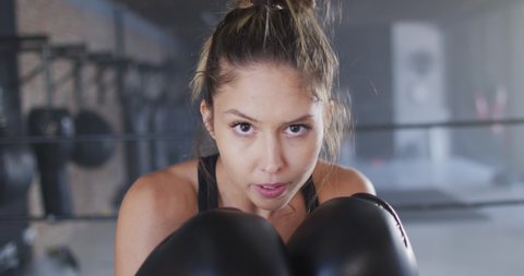 Video of fit caucasian woman boxing at gym. active, fit, sporty and healthy lifestyle, exercising at gym concept.