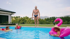 Group of cheerful seniors in swimming pool outdoors in backyard, jumping. - Powered by Shutterstock - Get 15% off with code: PIKWIZARD15