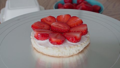 The process of making a bento small cake for one. Summer cake asian with strawberries and cream. Delicious beautiful dessert. Small bento cake gift holiday. Korean style cakes in box for one person.