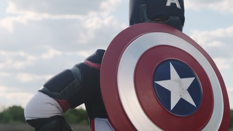 Close-up of the Civil War superhero Captain America with a shield. Captain America appears from the American shield. Russia, Rostov-on-Don May 17, 2022. Slow motion
