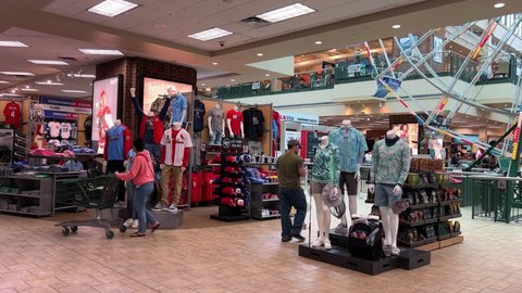 Springfield, IL USA - May 2, 2022: A display of St. Louis Cardinals and Chicago Cubs baseball clothing for sale at the Scheels Sporting Goods store in Springfield, Illinois.