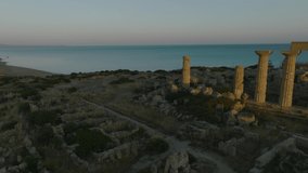 Aerial shot with drone of Selinunte at sunset. Archaeological site of the Mediterranean. Acropolis, Colle Manuzza, Eastern Hill, Colle Gaggera, Handicraft District, Byzantine Baptistery.
