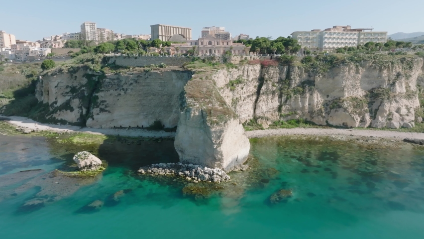 Drone shooting of the coast of Sciacca in Sicily. Harbor with fisherman, costa della volpe, castle and panoramic view of the city of Sciacca. Dixmunde sea war memorial and thermal baths.