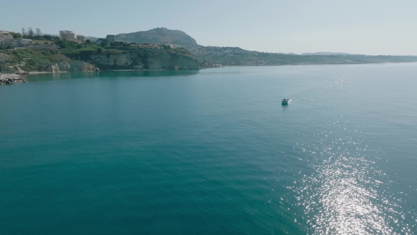 Drone shooting of the coast of Sciacca in Sicily. Harbor with fisherman, costa della volpe, castle and panoramic view of the city of Sciacca. Dixmunde sea war memorial and thermal baths.