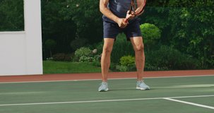 Video of focused of biracial senior man playing tennis on tennis court. active retirement lifestyle, senior relationship and tennis training concept.