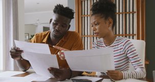 Video of focused african american couple planning home budget. relationship, finance, money and responsibility concept.