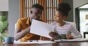 Video of focused african american couple planning home budget. relationship, finance, money and responsibility concept.