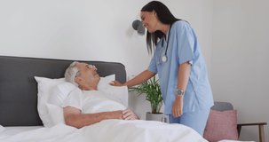 Animation of biracial female doctor taking care of caucasian senior man. seniors health and nursing home lifestyle concept digitally generated video.