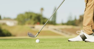 Video of legs of caucasian man playing golf on golf field. sporty, active lifestyle and playing golf concept.