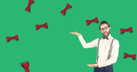 Animation of happy caucasian man over green background with falling bow ties. bow tie day and clothes concept digitally generated video.