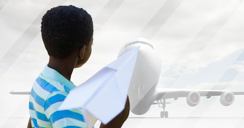 Animation of african american boy playing with paper plane over silhouette of plane. national aviation day and celebration concept digitally generated video.