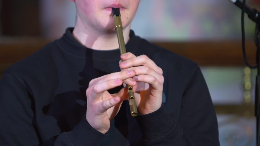 Young person playing traditional tin whistle musical woodwind instrument Ireland Royalty-Free Stock Footage #1090428181