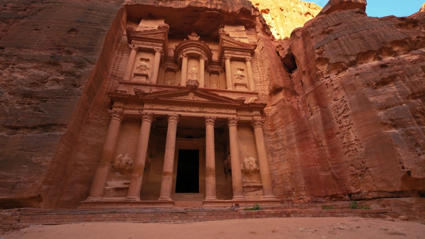The Treasury at Petra, historic UNESCO heritage site carved into sandstone in Jordan front view and upward pan. Famous Indiana Jones Last Crusade filming location and tourist destination Khaznet. | Shutterstock HD Video #1090430495