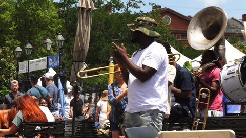 New Orleans , LA , United States - 04 22 2022: Brass band plays in Jackson Square for tips from a crowd during French Quarter Fest in New Orleans