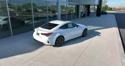 Lancaster , PA , United States - 05 08 2022: New Lexus sports car coupe for sale at dealership. Aerial orbit by showroom.