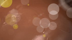 Animation of dots over melted milk chocolate. sweets, desserts and chocolate concept digitally generated video.