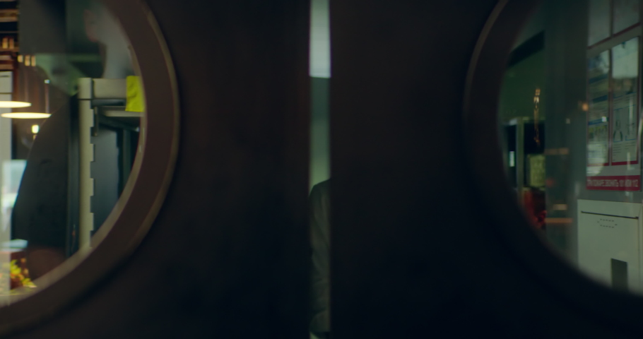 TRACKING Caucasian male chef walking out of commercial restaurant kitchen through the swinging doors. Shot with 2x anamorphic lens Royalty-Free Stock Footage #1090435705