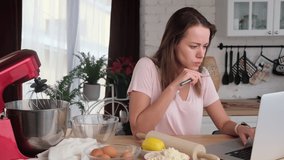 Woman in the kitchen watching video recipe and tutorial sweet dessert