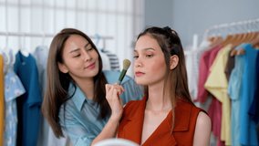 Happy female make-up artist using cosmetics to make up young model working at fashion house studio checking beauty on face taking make up time happily with model, Happy make up concept