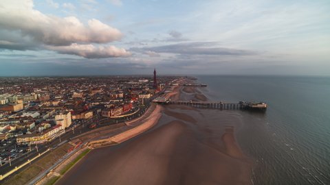 Establishing Aerial View Shot of Blackpool UK, Lancashire, England United Kingdom, wonderful afternoon, circling left over the beach