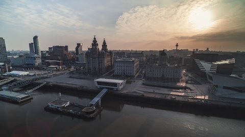 Establishing Aerial View Shot of Liverpool UK, Merseyside, England United Kingdom, sun breaking clouds,  rise up crane shot