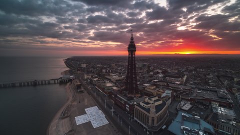 Establishing Aerial View Shot of Blackpool UK, Lancashire, England United Kingdom, divine light, sunrise, push out along the beach