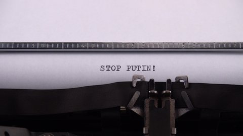 Kyiv, UKRAINE - APRIL 02, 2022: Typing phrase "STOP PUTIN !" on retro typewriter. 